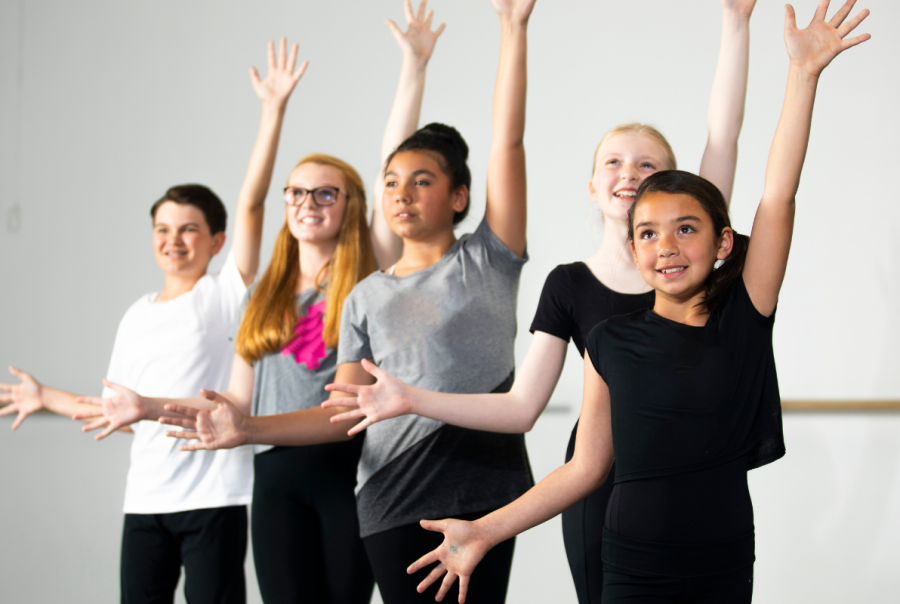 Kids participating in a Musical Theatre Central Coast class, learning singing, dancing, and acting